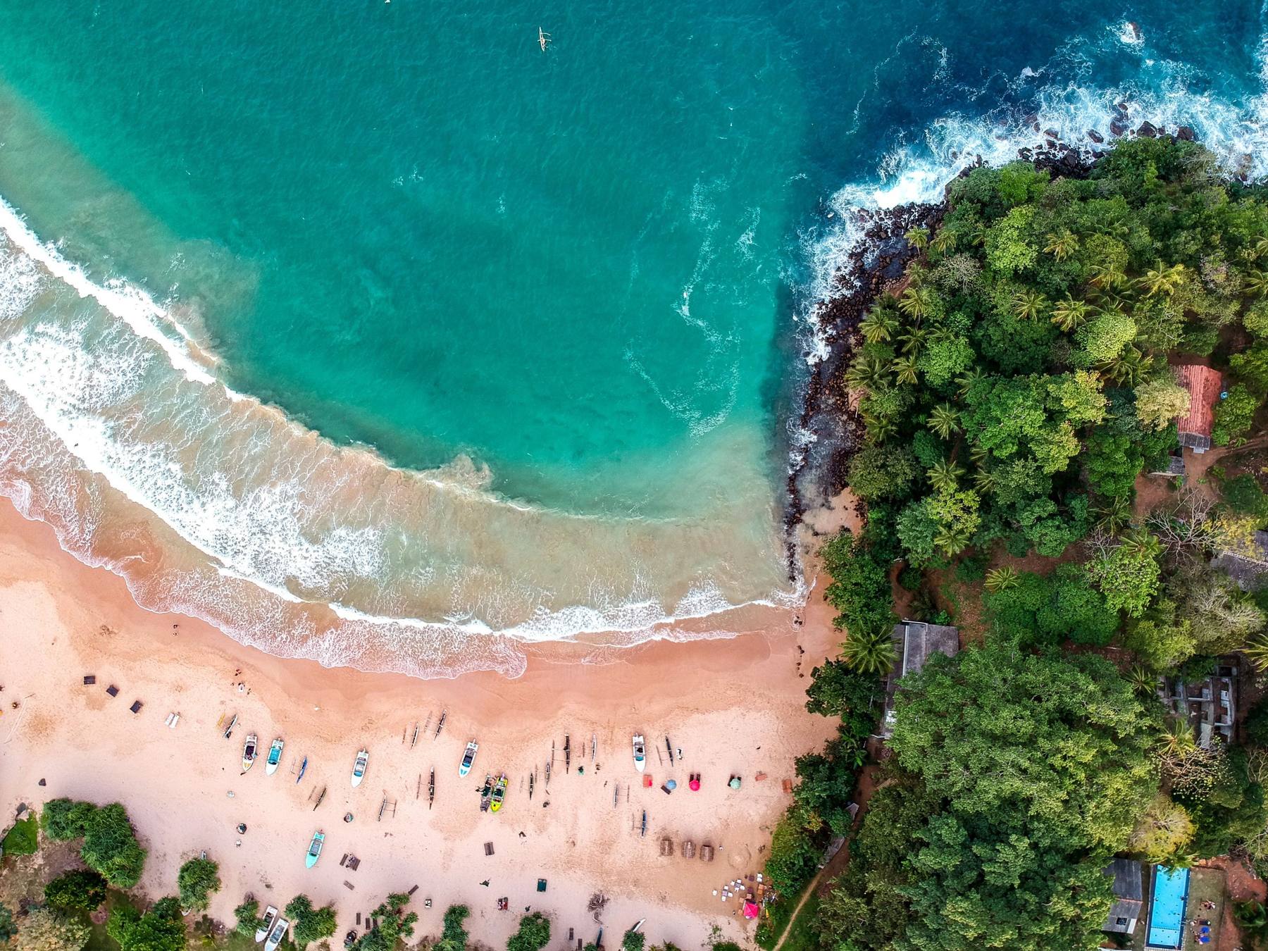 Aerial view of a turquoise bay and golden beach